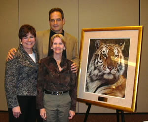 Peggy Kirkpatrick, director of the Central Missouri Food Bank, presented Coach Pinkel with a framed picture of a tiger to share with his team